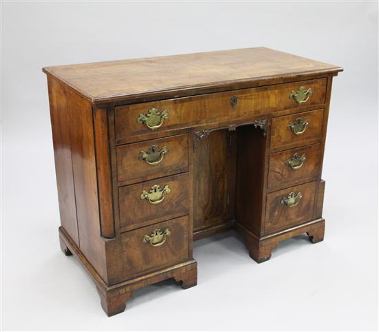 A George II walnut and crossbanded kneehole desk, W.3ft 3in.